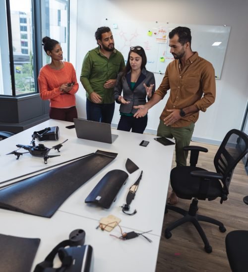 Diverse group of creative colleagues discussing work and brainstorming at meeting. modern office of a creative design business.